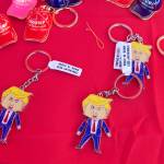 Trump pins with Made in China tags are displayed on a vendor table at the Save America Rally on Saturday. The manager of the merchandise says virtually everything else is made in the United States. (Mark Sabbatini / Juneau Empire)