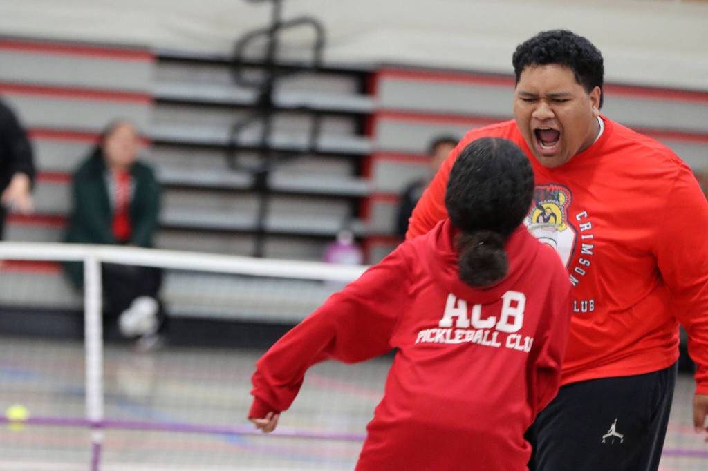Taufa Toetuu and Loni Veikoso celebrate during a pickleball match Saturday at Floyd Dryden Middle School. (Ben Hohenstatt / Juneau Empire)