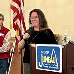President of the Greater Juneau Chamber of Commerce Wayne Jensen watches as owner and director of Rain Coast Data Meilani Schijvens presents the results of an annual business climate survey. (Jonson Kuhn / Juneau Empire)