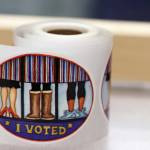 A roll of I voted stickers await voters on Saturday at the Alaska Division of Elections office in Juneau. A federal judge on Thursday denied a request to block campaign finance provisions of a ballot measure approved by Alaska voters in 2020. (Ben Hohenstatt / Juneau Empire File)