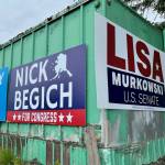 Campaign signs for Republican candidates leading in a recent poll in their respective races for governor, U.S. House and U.S. Senate hang from a structure near Juneau International Airport on Monday. Nick Begich and Lisa Murkowski, who had to file federal campaign donation reports by last Friday, also report having the most cash-on-hand by far in their races. (Jonson Kuhn / Juneau Empire)
