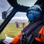 A Coast Guard Air Station Kodiak MH-60 Jayhawk helicopter pilot watches as the aircrew assists overdue boaters, July 18, 2022. (Lt. Scott Kellerman / U.S. Coast Guard)
