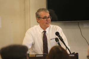 City and Borough of Juneaus city manager, Rorie Watt, speaks to a crowd of people as they enjoy a slice of lasagna at the Greater Juneau Chamber of Commerces weekly luncheon on Thursday afternoon. (Clarise Larson / Juneau Empire)
