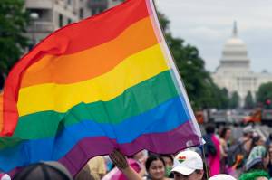 With the U.S. Capitol in the background, a person waves a rainbow flag as they participant in a rally in support of the LGBTQIA+ community at Freedom Plaza, Saturday, June 12, 2021, in Washington. The U.S. House overwhelmingly approved legislation Tuesday, July, 19, 2022, to protect same-sex and interracial marriages amid concerns that the Supreme Court ruling overturning Roe v. Wade abortion access could jeopardize other rights criticized by many conservative Americans. (AP Photo / Jose Luis Magana)