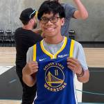 Joseph Tagaban poses with a newly signed Golden State Warriors jersey after spending the day with his NBA idol Klay Thompson, whose given him inspiration through his battle with cancer. (Courtesy photo / Tagaban family)