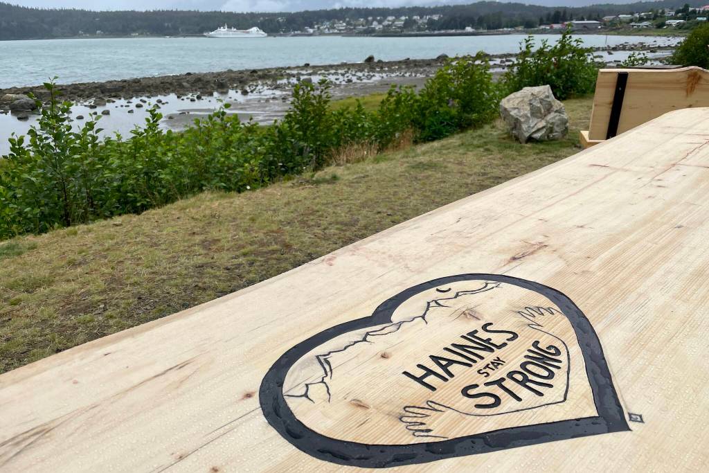 A recently-installed table memorializes the losses from the 2020 landslides in Haines, visible in the background (Michael S. Lockett / Juneau Empire)