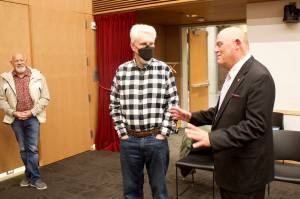 David Keith, right, an Oklahoma hospital leader who is among the three finalists for the CEO position at Bartlett Regional Hospital, chats with Bartlett board members Hal Geiger and Kenny Solomon-Gross during a meet-and-greet Friday at the Andrew P. Kashevaroff Alaska State Library, Archives and Museum. (Mark Sabbatini / Juneau Empire)