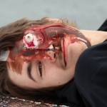 Kelton Griffith roleplays as a griveiously injured casualty during an exercise simulating a plane crash at Juneau International Airport on July 23, 2022. (Ben Hohenstatt / Juneau Empire)