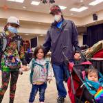 Students show off their new backpacks at Central Council of the Tlingit and Haida Indian Tribes of Alaskas annual backpack distribution at Elizabeth Peratrovich Hall on July 23, 2022. (Michael S. Lockett / Juneau Empire)