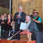 Courtesy Photo / Alaska Federation of Natives
Alaska Gov. Mike Dunleavy holds up a bill providing state recognition of the 229 federally recognized Alaska Native tribes after signing it Thursday during a ceremony at the Alaska Native Heritage Center in Anchorage. He also signed a bill authorizing tribes to establish compact schools under a pilot program.