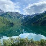 Blue sky, clouds and mountains are reflected in the Salmon Creek Reservoir on Aug. 20, 2022. (Courtesy Photo / Denise Carroll)
