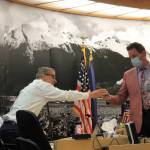 City Manager Rorie Watt chats with member of the Assembly during a break in Monday nights meeting. (Clarise Larson/ Juneau Empire)