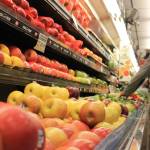 A shopper reaches for some fruit in the produce section at Super Bear IGA. City and Borough of Juneau members OK’d an ordinance that approves funding for a third party to survey Juneau residents on the question of the city should consider removing the sales tax on food. (Clarise Larson / Juneau Empire)