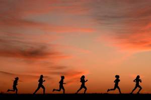High school students run at sunset as they practice for the track and field season Monday, Feb. 28, 2022, in Shawnee, Kan. New research hints that even simple exercise just might help fend off memory problems. While physical activity helps keep healthy brains fit, it's not clear how much it helps once memory starts to slide.  (AP Photo / Charlie Riedel)