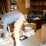 J.T. Collins, left, and Flint Allred sort through the backlog of mail at the Tenakee Springs post office that accumulated as of Monday morning when the post office was closed for more than a week due to their absence and the departure of a third employee at the post office. (Mark Sabbatini / Juneau Empire)