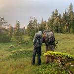 The author and his high school basketball coach Don Busse, survey a map of a mountain in the early light of Aug. 16, opening day for non-federally qualified users on parts of Prince of Wales Island where Jeff Lund grew up. (Jeff Lund / For the Juneau Empire)