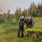 The author and his high school basketball coach Don Busse, survey a map of a mountain in the early light of Aug. 16, opening day for non-federally qualified users on parts of Prince of Wales Island where Jeff Lund grew up. (Jeff Lund / For the Juneau Empire)