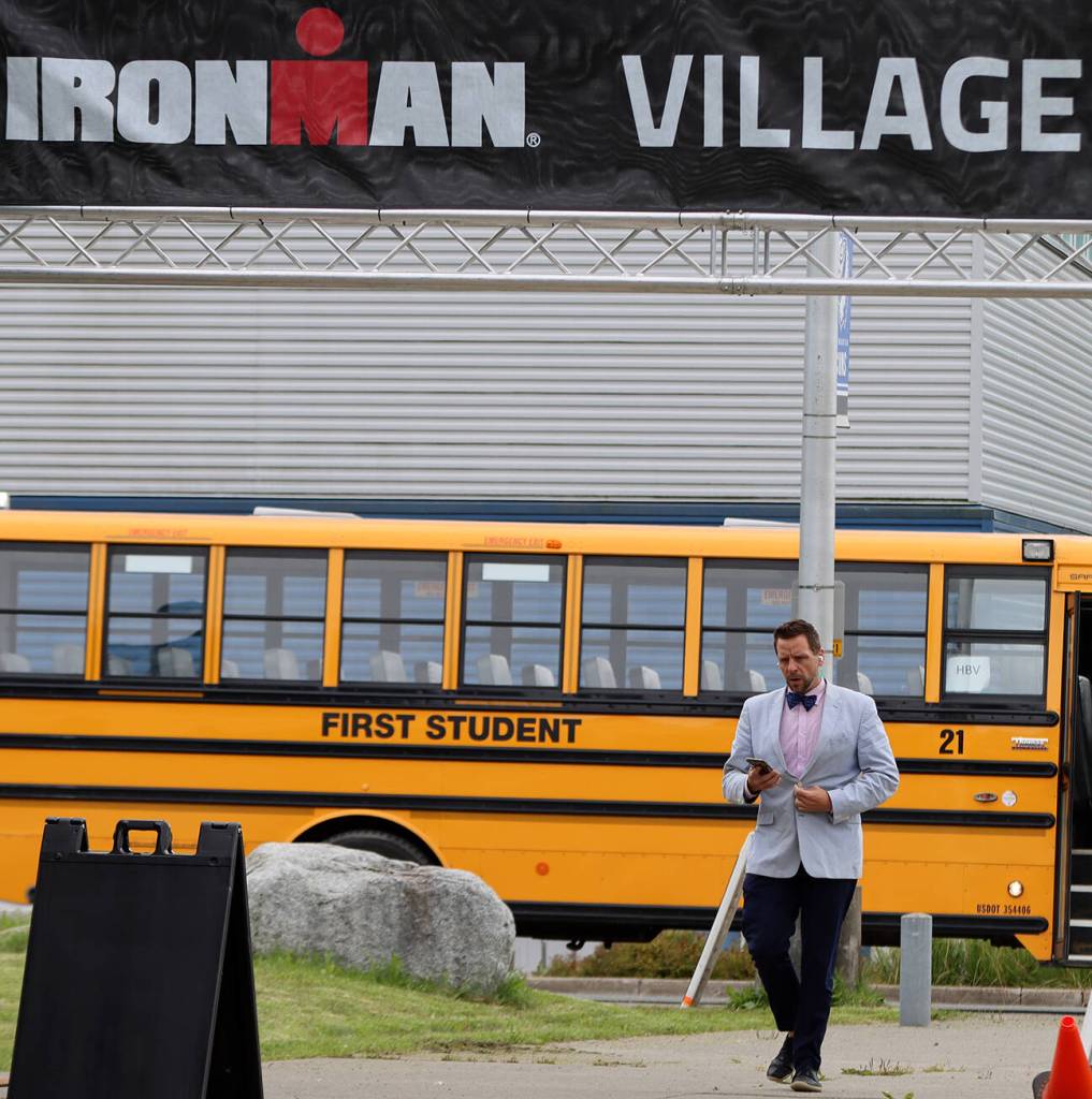 Jeff Rogers, the City and Borough of Juneaus financial director, heads to the Ironman Village at Thunder Mountain High School on Thursday afternoon to attend the athlete briefing event. (Ben Hohenstatt / Juneau Empire)