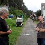 Kevin Allred, left, and his son, Flint, discuss options for finding building project materials in front of the elder Allreds house along the main street in Tenakee Springs on Tuesday. Both are among the high percentage of residents who say they make a living doing odd jobs. That diversity of skills proves useful in other ways in the tiny community such as when the father made a mechanical hand from spare parts for his son when he broke his hand a year ago. (Mark Sabbatini / Juneau Empire)