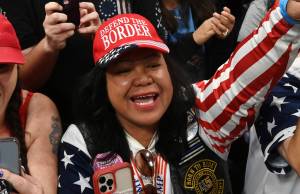 Mimi Israelah, center, cheers for Donald Trump inside the Alaska Airlines Center in Anchorage, Alaska, during a rally Saturday July 9, 2022. Two Anchorage police officers violated department policy during a traffic stop last month when Israelah, in town for a rally by former President Donald Trump showed a "white privilege card" instead of a driver's license and was not ticketed. (Bill Roth / Anchorage Daily News)
