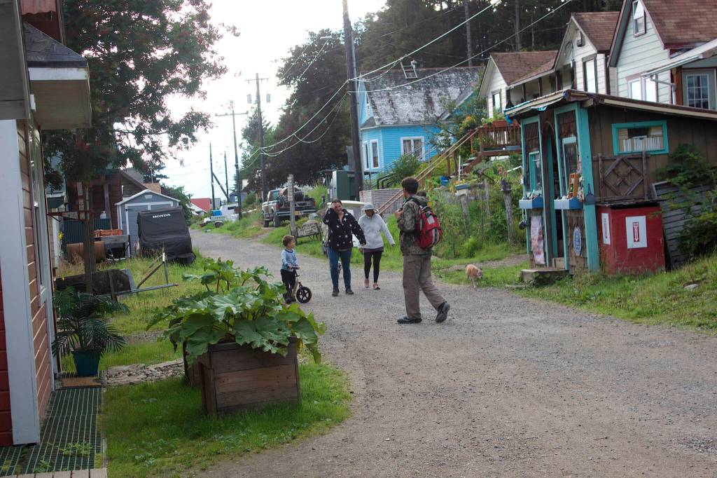 A family walking down the main road of Tenakee Springs to the seaplane dock on Wednesday is an increasingly rare sight in the community of 112 people. Mayor Dan Kennedy said there were about 30 school-age children when he moved to Tenakee more than 30 years ago, but only seven live there now. (Mark Sabbatini / Juneau Empire)