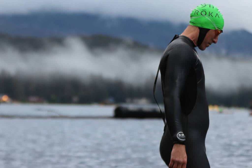 An ironman athlete wades into Auke Lake. (Ben Hohenstatt / Juneau Empire)