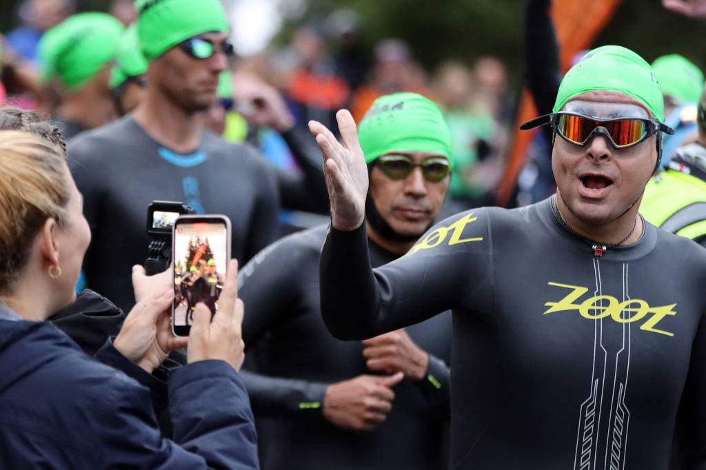 Some swimmers vamped for spectators and supporters before the swimming leg of Ironman Alaska held Sunday. (Ben Hohenstatt / Juneau Empire)