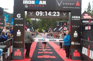 Alex Whetman, suffering leg cramps and numb hands moments after winning the inaugural Ironman Alaska on Sunday, found something sufficient to divert his attention a minute or so later while in the midst of explaining his victory to the surrounding cameras and voice recorders. Whetman, a Salt Lake City resident participating in his fifth Iron Man, finished with a time of 9 hours, 11 minutes and 17 seconds, more than 12 minutes ahead of the second-place finisher. (Mark Sabbatini / Juneau Empire)