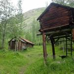 A cache, at right in photo, is an elevated structure northerners use to keep food and other supplies away from dogs and wild animals. (Courtesy Photo / Ned Rozell)