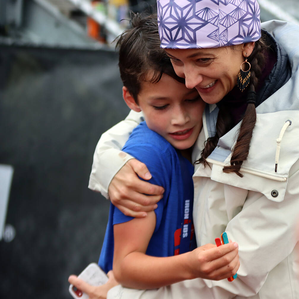 Amber Treston gives 9-year-old Austin Treston a squeeze after the Juneau boy was the first to finish his heat in the Ironkids Fun Run event held Saturday at Thunder Mountain High School. Austin credited his success to pacing. (Ben Hohenstatt / Juneau Empire)