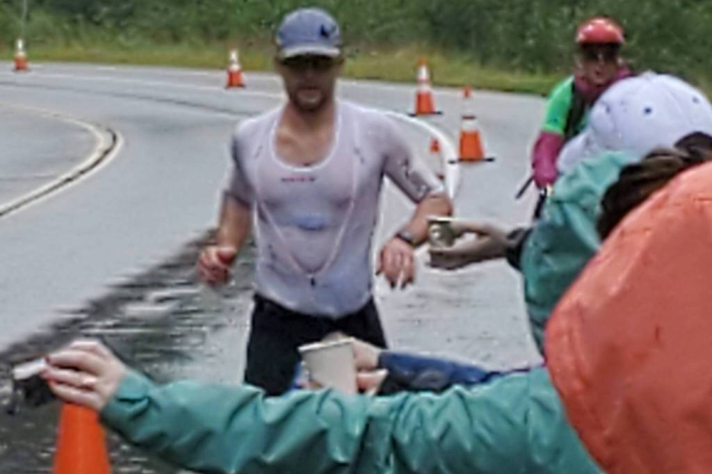 Alex Whetman, winner of the Ironman Alaska featured running through Southeast Alaska Food Banks aid station. (Courtesy photo / Chris Schapp)