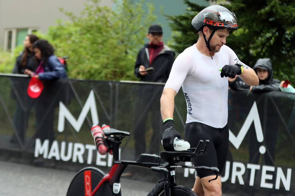 Eventual Ironman Alaska winner Alex Whetman takes a look at his wrist before heading to the starting point of the bike portion of the endurance triathlon. Whetman said the cycling poriton of the race proved to be the most difficult leg. (Ben Hohenstatt / Juneau Empire)