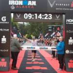 Alex Whetman, suffering leg cramps and numb hands moments after winning the inaugural Ironman Alaska on Sunday, found something sufficient to divert his attention a minute or so later while in the midst of explaining his victory to the surrounding cameras and voice recorders. Whetman, a Salt Lake City resident participating in his fifth Iron Man, finished with a time of 9 hours, 11 minutes and 17 seconds, more than 12 minutes ahead of the second-place finisher. (Mark Sabbatini / Juneau Empire)