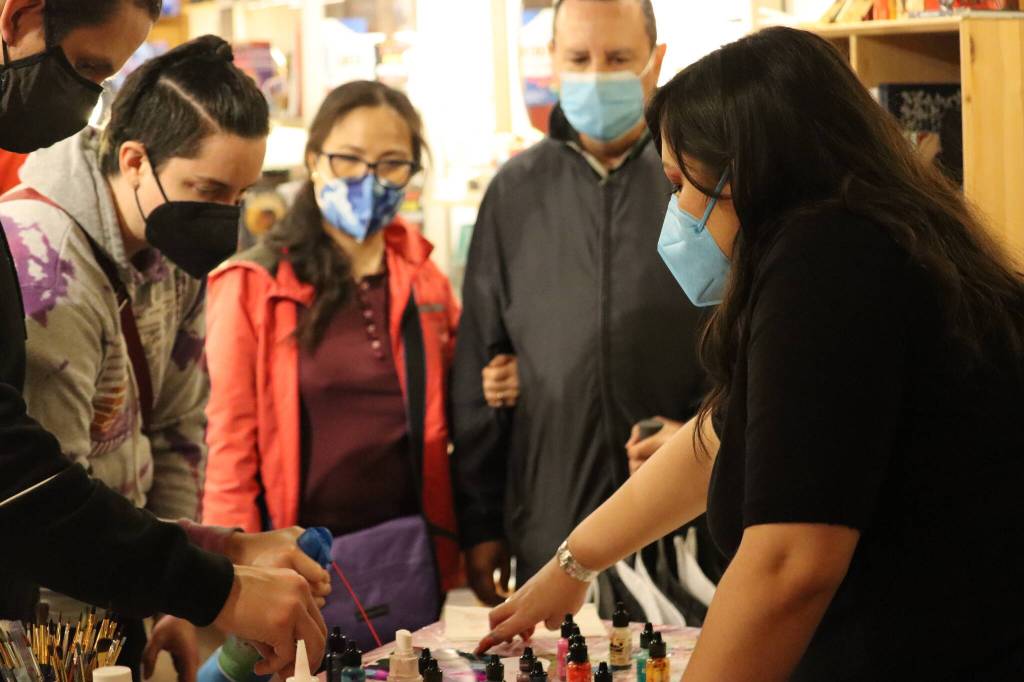 Crystal Jackson gives demonstrations of alcohol inks to a packed house during her interactive First Friday event at Kindred Post located at 145 S. Franklin St. (Jonson Kuhn / Juneau Empire)