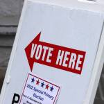 A sign points voters toward an election center during the May special primary election. (Ben Hohenstatt / Juneau Empire File)
