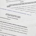 The motion by the Justice Department to the U.S. District Court South District of Florida to unseal the search warrant the FBI received before searching the Florida estate of former President Donald Trump, is photographed Thursday, Aug. 11, 2022. Attorney General Merrick Garland cited the "substantial public interest in this matter" in announcing the request. (AP Photo / Jon Elswick)