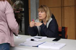 City Borough of Juneaus senior project planner Beth McKibben sits outside Foodland IGA on Saturday to talk to residents about the public review draft of the CBJs blueprint area plan for the future of downtown Juneau, which recently was released for the public to comment on. (Clarise Larson / Juneau Empire)