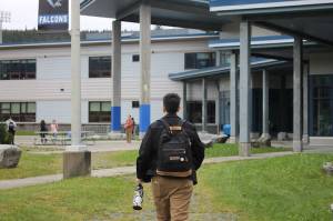 A student heads to the main entrance of Thunder Mountain High School to start the first day of school. (Clarise Larson / Juneau Empire)