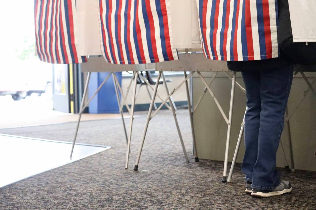 Alaska resident casting her vote at Auke Bay Ferry Terminal among a steady flow of voters in Tuesday mornings primary election.