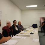 Election official sit by the polling booths at the Mendenhall Mall precinct to help voters with any questions or confusion for this years elections for Alaskas open U.S. House seat and a pick-one primary for U.S. Senate. (Clarise Larson / Juneau Empire)
