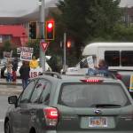 Supporters of candidates from various parties in the races for U.S. House, U.S. Senate, governor and Alaska State Legislature waves signs during rush hour in the rain at the intersection of Egan Drive and 10th St. (Mark Sabbatini / Juneau Empire)