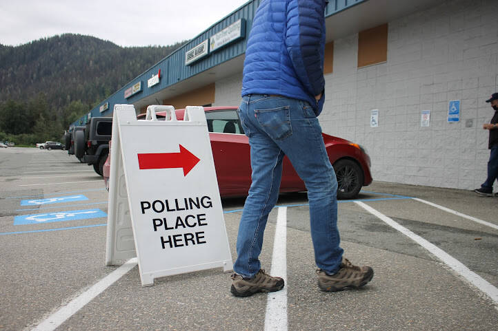 A resident walks to the Mendenhall Mall precinct to cast their vote for this years atypical election day. (Clarise Larson / Juneau Empire)