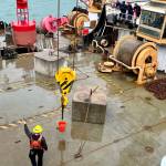 Another one of the games held at the Buoy Tender Olympics was boom spot, which consists of each team moving a bucket of water with a crane from various locations without spilling it. (Jonson Kuhn / Juneau Empire)