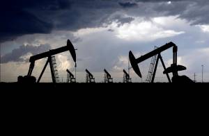 A thunderstorm passes between Midland and Odessa, Texas, just behind an array of pump jacks on Thursday, May 14, 2020. While the Inflation Reduction Act concentrates on clean energy incentives that could drastically reduce overall U.S. emissions, it also buoys oil and gas interests by mandating leasing of vast areas of public lands and off the nation’s coasts. (Eli Hartman / Odessa American)