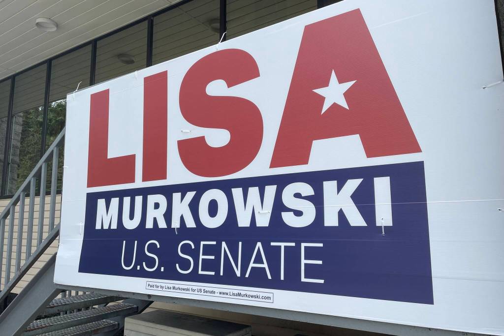 A political sign hangs from a business. Rules around standalone political signs are tightly regulated in Alaska. (Michael S. Lockett / Juneau Empire)