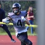 Jayden Johnson smiles as he reaches the end zone in the fourth quarter. The Huskies were victorious in their home opener against Bartlett High School. The score extended Juneaus lead to 26-14 and helped stave off a turnover-fueled comeback bid by Bartlett. The Huskies went on to win 33-14. (Ben Hohenstatt / Juneau Empire)