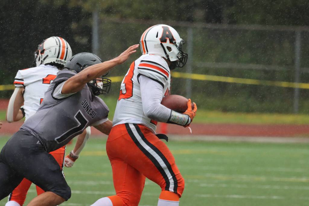 Juneaus Jamal Johnson (7) catches up to Wests Toby Miller (3) during the Huskies win on Saturday. (Ben Hohenstatt / Juneau Empire)