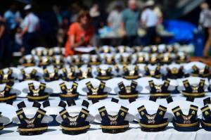 The new hats and shoulder bars for the graduates sit on a table before the start of the U.S. Coast Guard Academys 141st Commencement Exercises Wednesday, May 18, 2022 in New London, Conn. The Coast Guard Academy is disenrolling seven cadets for failing to comply with the militarys COVID-19 vaccination mandate, after their requests for religious exemptions were denied and they were ordered to leave campus. The academy in New London, Connecticut, confirmed the disenrollments Tuesday, Aug. 30, 2022, The Day newspaper reported. (AP Photo / Stephen Dunn, File)