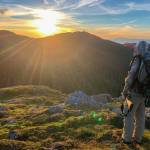 The author looks over a mountain near Ketchikan in the late evening sun on an alpine deer hunt. (Courtesy Photo / Abby Lund)