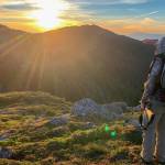The author looks over a mountain near Ketchikan in the late evening sun on an alpine deer hunt. (Courtesy Photo / Abby Lund)